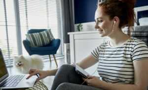 Cheerful woman learning at home online